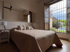 a bedroom with a large bed and a large window at Casa Rocamora - Victoria Entre Ríos in Victoria