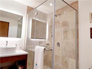 a bathroom with a shower and a sink at Serenada Boutique Condo Near 5th Ave in Playa del Carmen