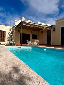 a swimming pool in front of a house at Casa Rocamora - Victoria Entre Ríos in Victoria