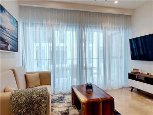 a living room with a couch and a coffee table at Serenada Boutique Condo Near 5th Ave in Playa del Carmen