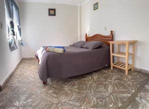 a bedroom with a bed and a table on a carpet at Tango in Sucre +28 photos