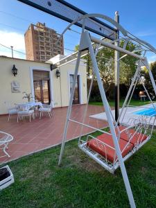 a swing set in the yard of a house at Casa Rocamora - Victoria Entre Ríos in Victoria