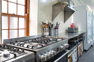 a kitchen with a stove top oven in a kitchen at Mad Monkey Broadway in Sydney