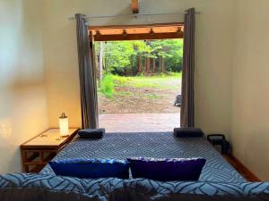 a bedroom with a bed in front of a door at Ocean Forest Bungalows- Deluxe Glamping in Fort Bragg