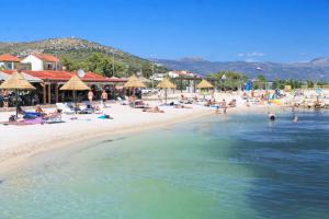 a group of people on a beach near the water at Rooms with a parking space Trogir - 24051 in Trogir