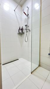 a shower with a glass door in a bathroom at Kozy House in Gangnam in Seoul