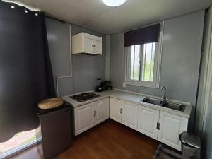 a small kitchen with white cabinets and a sink at Abitare lodge Mezcala #2 in Isla de Mezcala