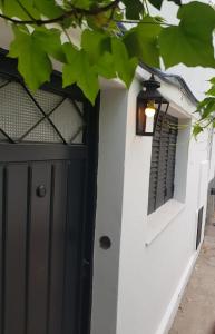 a black door on a white wall with a window at Casa Palihue por día in Bahía Blanca