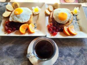 two plates with eggs and fruit and a cup of coffee at Reggae Vibes De Romblon in Agpanabat +21 photos