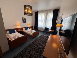 a hotel room with two beds and a table at Luitpold Hotel in Nuremberg