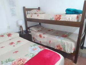 a room with two bunk beds with flowers on them at Hostel Trinidad in San Salvador de Jujuy