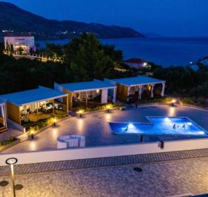 a resort with a swimming pool at night at Ayana Mobile Home in Orebić
