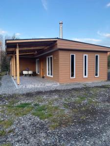 a small house with a patio in front of it at Casa Villarrica, villa los Chilcos in Villarrica