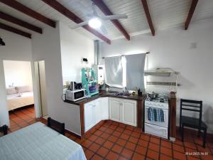 a kitchen with a sink and a stove top oven at Carnaval in Gualeguaychú