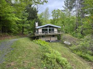 a house in the middle of a forest at Cabin on the hill Ascutney in Jenneville