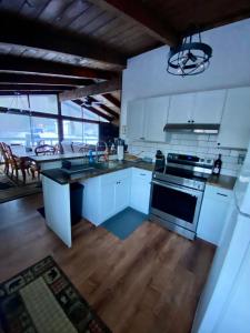 a kitchen with white cabinets and a stove top oven at Cabin on the hill Ascutney 