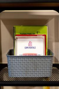 a basket of books sitting on a shelf at 505 Heart of CDMX 1Bdrm 1bath apt AC Rooftop in Mexico City +38 photos