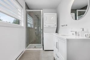 a white bathroom with a shower and a sink at Chalet MoCo in Saint Come +27 photos