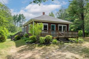 a small house with a porch and a deck at Maine Coastal Cottage in Wells
