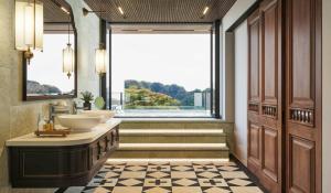 un bagno con due lavandini e una grande finestra di La An Tam Coc Hotel & Rooftop Bar a Vũ Lâm