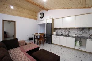 a living room with a couch and a kitchen at Lakeview Villa Nardi in Ksamil