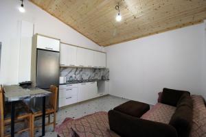 a living room with a couch and a kitchen at Lakeview Villa Nardi in Ksamil