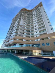 a large building with a pool in front of it at Studio One 1107 in Juazeiro do Norte