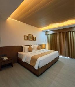 a bedroom with a large bed and a large window at TIKA Lombok in Kuta Lombok +51 photos