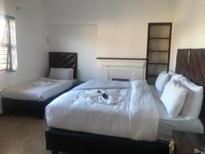 a hotel room with two beds and a fireplace at Duminy House Guest Lodging in Bellville