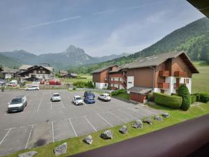 a view of a parking lot with cars parked at Appartement au pied des pistes à Bernex avec balcon et parking - FR-1-498-117 in Bernex