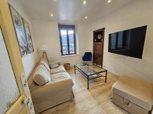 a living room with a couch and a flat screen tv at Maison de ville rénovée avec garage privatif à Épinal - FR-1-589-834 in Épinal