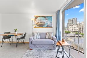 a living room with a couch and a table at Ilikai Marina Studios in Honolulu