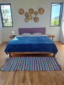 a bedroom with a bed with a blue comforter at Chez Mya in Cascavelle +32 photos