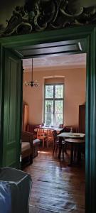 a living room with a table and a window at Rózsilak in Balatonfüred