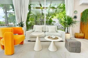 a living room with orange and white furniture at Haad Yao Villa 13 Luxury Sea View & Pool in Koh Phangan