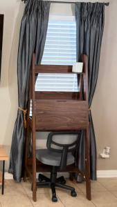 a desk and a chair in front of a window at 1 BR 1 Bath Airport SpaceX LNG WashDry Yard Patio Pets in Brownsville
