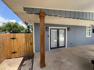 a front door of a house with a wooden pole at 1 BR 1 Bath Airport SpaceX LNG WashDry Yard Patio Pets in Brownsville