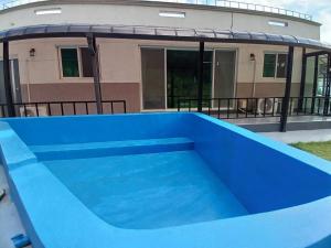 a blue swimming pool in front of a building at Yangyang Haewasol House in Yangyang