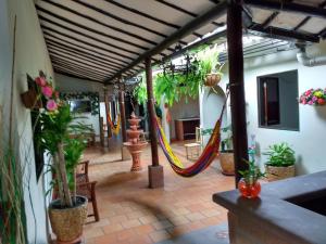 a patio with a hammock and potted plants at Habitación 4 personas Hostal centro San Gil in San Gil