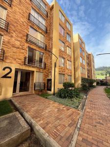 a brick walkway in front of a brick building at Confort 203 Apartamento Duitama in Duitama