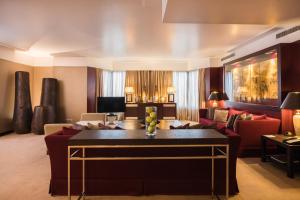 a living room with a couch and a table at Crowne Plaza Porto by IHG in Porto