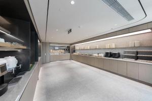 a large kitchen with a long hallway in a restaurant at JI Hotel Beijing Fangshan Commercial Street in Beijing +8 photos