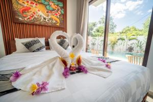 Ένα ή περισσότερα κρεβάτια σε δωμάτιο στο Jangga Nusa Villa by Bali Cabin +24 φωτογραφίες