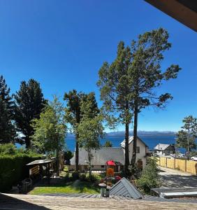 a view of a house with a tree at Hermosas Cabañas con vista al Nahuel Huapi in San Carlos de Bariloche +11 photos