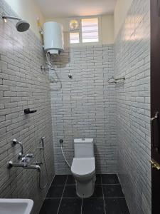 a bathroom with a toilet and a sink at ELCI Residence PG luxury womens hostel Tambaram in Chennai +6 photos