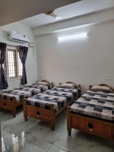 a room with three beds in a room at ELCI Residence PG luxury womens hostel Tambaram in Chennai
