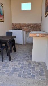a kitchen with a table and a table and a counter at Finca Darryl - Piscina y Relax - Playas Villamil in Hacienda Bella Esperanza +2 photos
