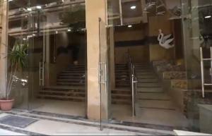 an open glass door of a building with stairs at Agouza 150m Apartment, new first rent in Cairo