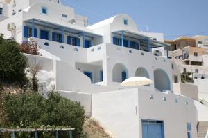 a white building with a lot of windows at Panselinos in Anafi