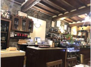 a bar in a restaurant with a counter and a bar sidx sidx at Locanda Il Gallo in Greve in Chianti